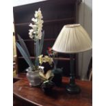 An artificial orchid in hexaganol jardinere; two other artificial flowers in pots; and a green &