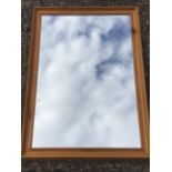 A pine framed rectangular mirror.