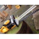 A JCB two-stroke petrol hedge trimmer, the machine complete with user manual.