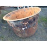 An old iron wash pot of circular cauldron form with flat lip.