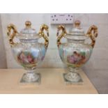 A pair of Meissen style porcelain urns & covers, with gilded serpent ring handles