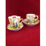 Two Meissen style porcelain chocolate cups & saucers decorated with alternating floral panels