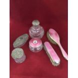 A Birmingham hallmarked three-piece ladies dressing table set with pink eglomis enamelling