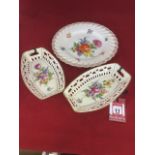 A pair of nineteenth century Dresden porcelain baskets painted with floral bases with pierced