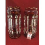 A pair of cranberry glass table crystals with crown shaped bowls