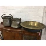 Two hammered North African copper cauldrons mounted with swing handles; and a large Victorian