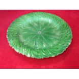 A leaf moulded nineteenth century plate in green glaze - marked with impressed flowerhead. (8in)