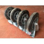 A set of four large trolley wheels. (4)