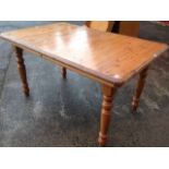 An extending pine dining table