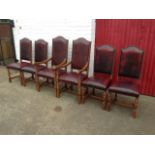 A set of six leather upholstered dining chairs