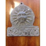 A lead firemark cast as a sun above number 425573