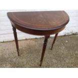 A 'D' shaped mahogany hall table, the moulded top inlaid with boxwood stringing, raised on turned