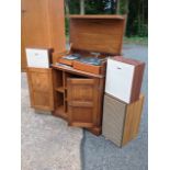 A carved oak hi-fi cabinet with linenfold panelled doors and roundel frieze