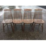 A set of four spindleback kitchen chairs with shaped seat raised