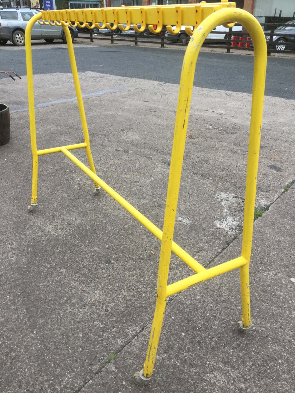 A painted school coatstand, with hooped supports on casters holding batons with pegs. - Image 2 of 3