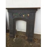 A late Victorian arts & crafts style cast iron fireplace
