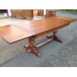 A large oak draw-leaf dining table