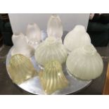 A pair of art nouveau vaseline glass lampshades of fluted square waved form; another three fluted