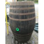 A massive oak barrel, the staves bound by ten metal strap bands.