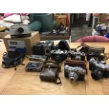 A boxed Gnome slide projector; and a collection of cameras