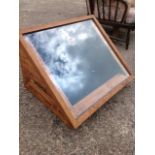 A display cabinet with angled glazed lid, the back with locking tongue & groove constructed box,