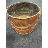 A cooper log bin with rolled rim, embossed with Viking ships on stylised waves