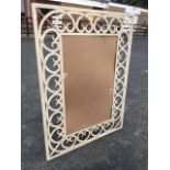 A rectangular wrought iron frame, formerly mirrored, with interlaced scrolled decorative painted