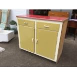 A 60s kitchen unit with formica top above two drawers, having cupboards below supported on a