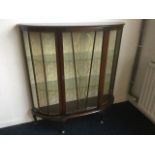 A 'D' shaped walnut display cabinet with glazed doors & glass shelves, raised on stub cabriole legs