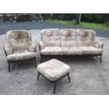 An Ercol spindleback three-seater sofa, armchair and stool,
