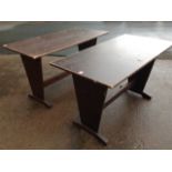 A pair of rectangular tables on tapering trestle style supports