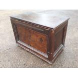 A panelled rectangular blanket box, with bobbin moulded frames raised on turned bun feet.