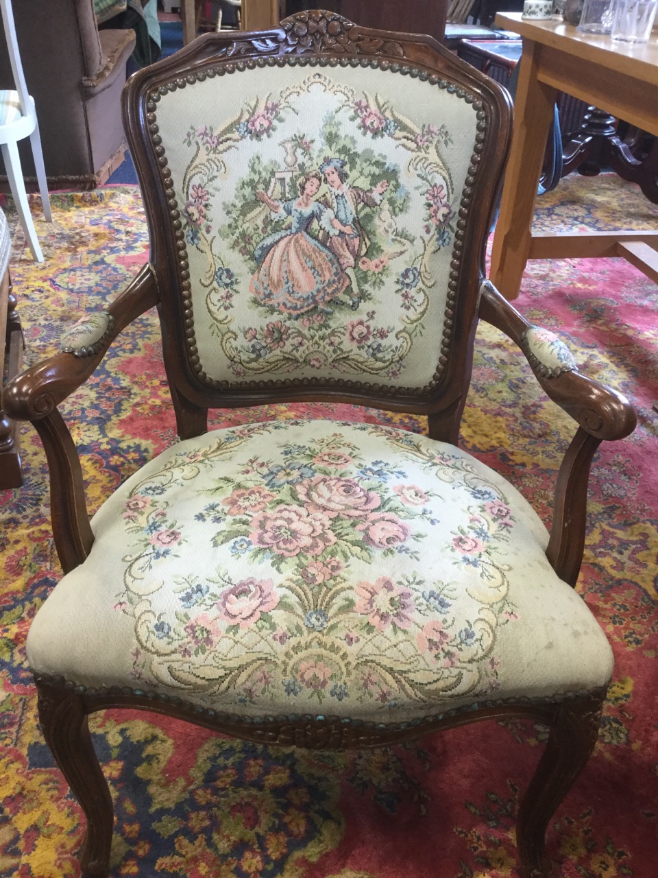 A stained fauteuil with studded tapestry upholstered back and seat