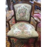 A stained fauteuil with studded tapestry upholstered back and seat