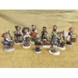 A collection of eleven Hummel child figurines on plinths. (11)