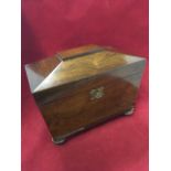 A Victorian rosewood tea caddy of sarcophagus shape having tablet panel to lid