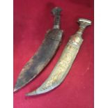 An eastern dagger with shaped embossed brass sheath