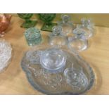 A pale blue glass dressing table set on tray moulded with butterflies