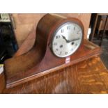 An Edwardian oak mantel clock, the domed case raised on bun feet