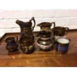 A collection of Victorian copper lustre jugs with pink and blue resist decoration