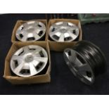 A set of four Vauxhall car wheels with trims. (4)