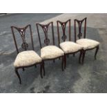 A set of four art nouveau upholstered dining chairs