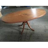 An oval mahogany coffee table