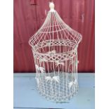 A tubular wirework bird cage