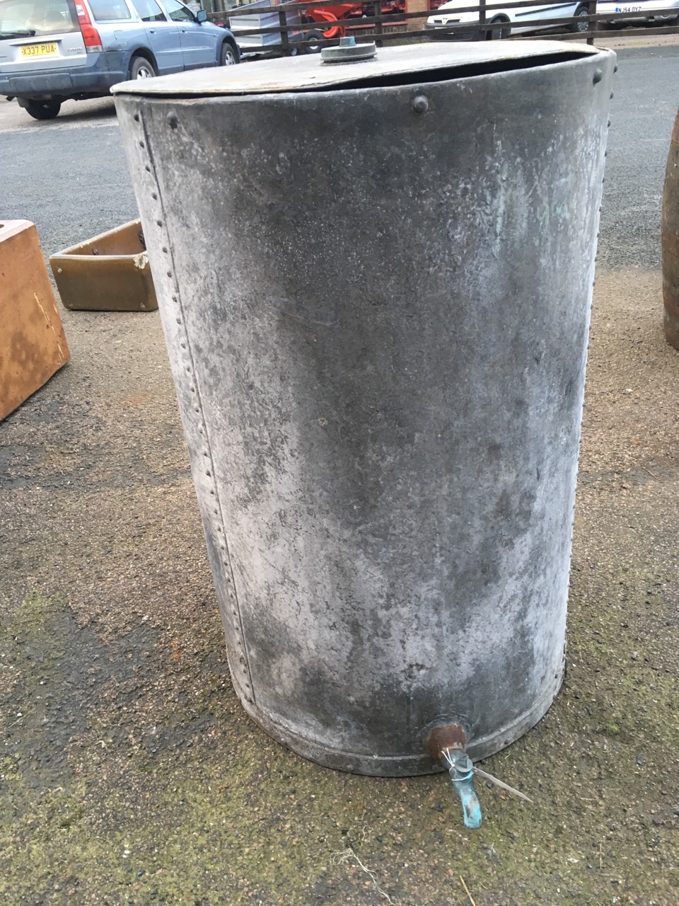 A large tubular galvanised tank of riveted construction