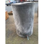 A large tubular galvanised tank of riveted construction