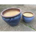 A graduated pair of blue glazed stoneware garden pots, the rims with scrafito incised decoration.