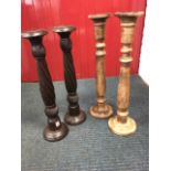 A pair of carved candlesticks with twisted columns; and another hardwood pair with turned columns.