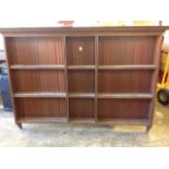 A mahogany plate rack with moulded dentil cornice