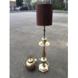 A tall brass tablelamp with tubular shade on baluster form and urn column